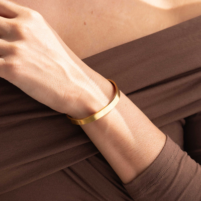 Engraved bracelet in silver with a gift box, bag, and card in the background