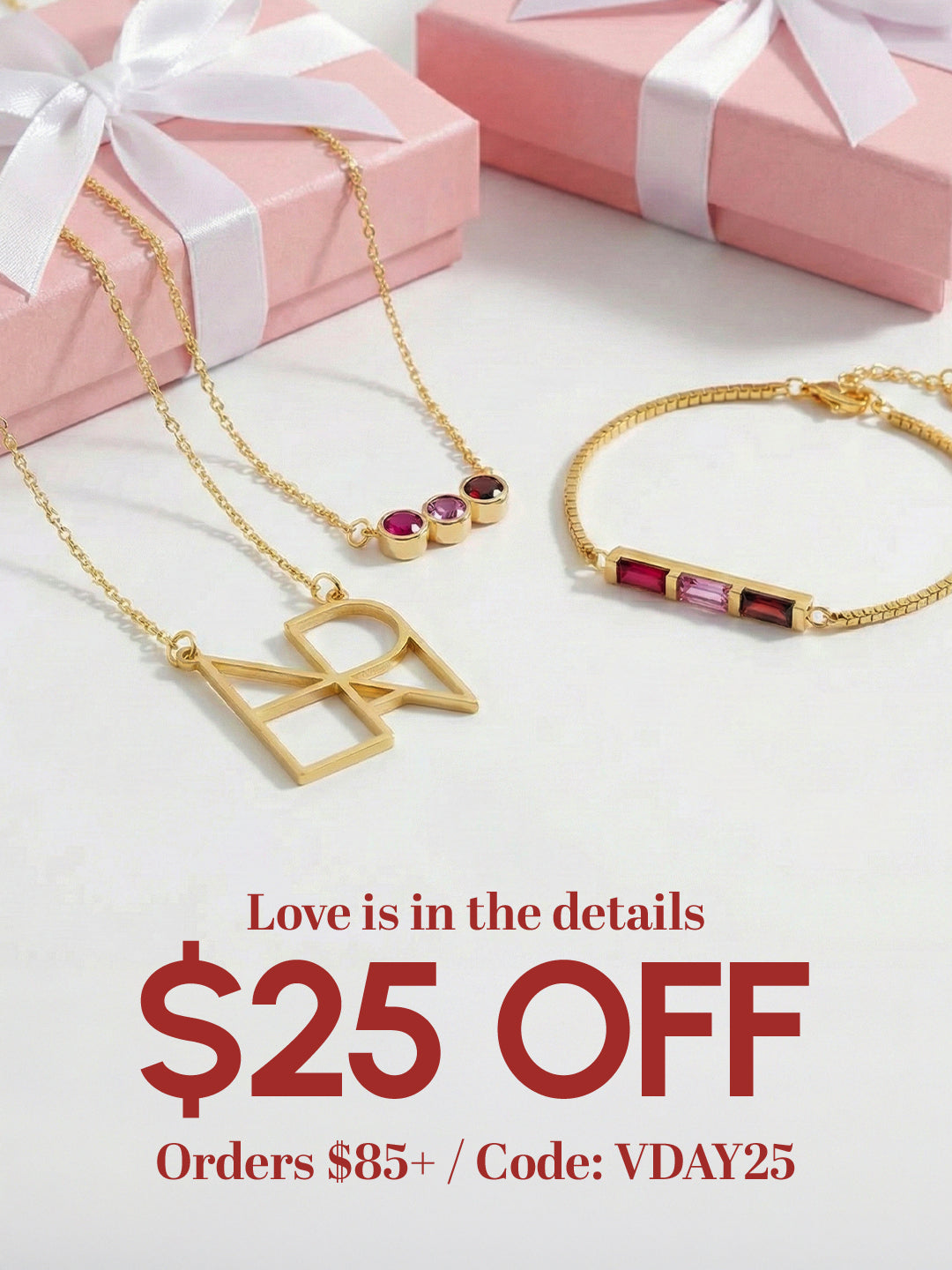 Gold jewelry with gemstones on a white surface with pink gift boxes, promotional text overlay.