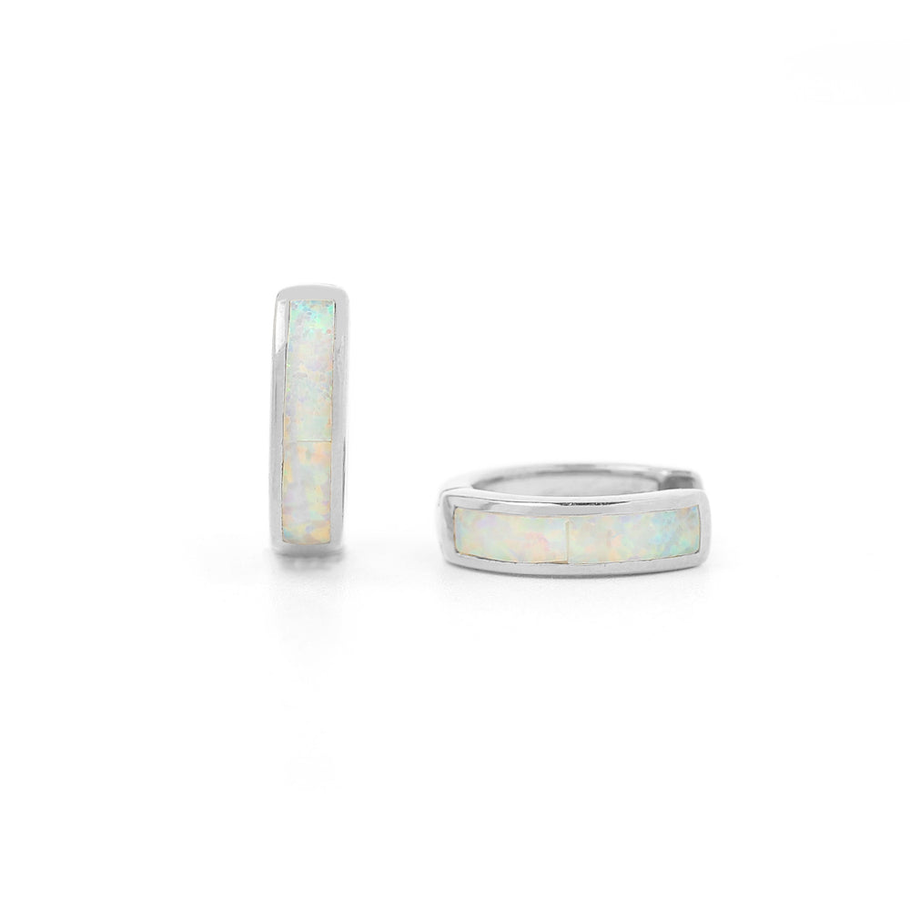 A pair of huggie hoop earrings with opal inlay, available in 18K gold over sterling silver or pure sterling silver.