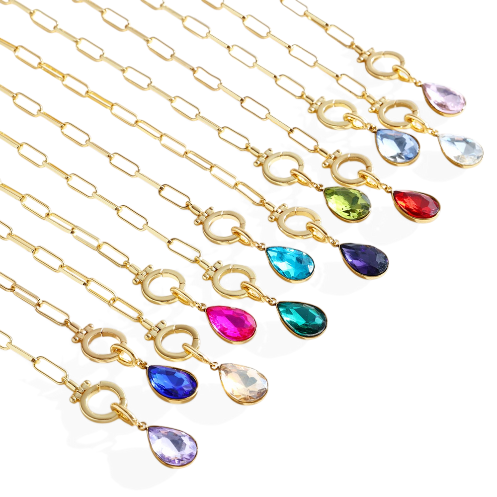 Gold necklaces with colorful teardrop pendants on a white background