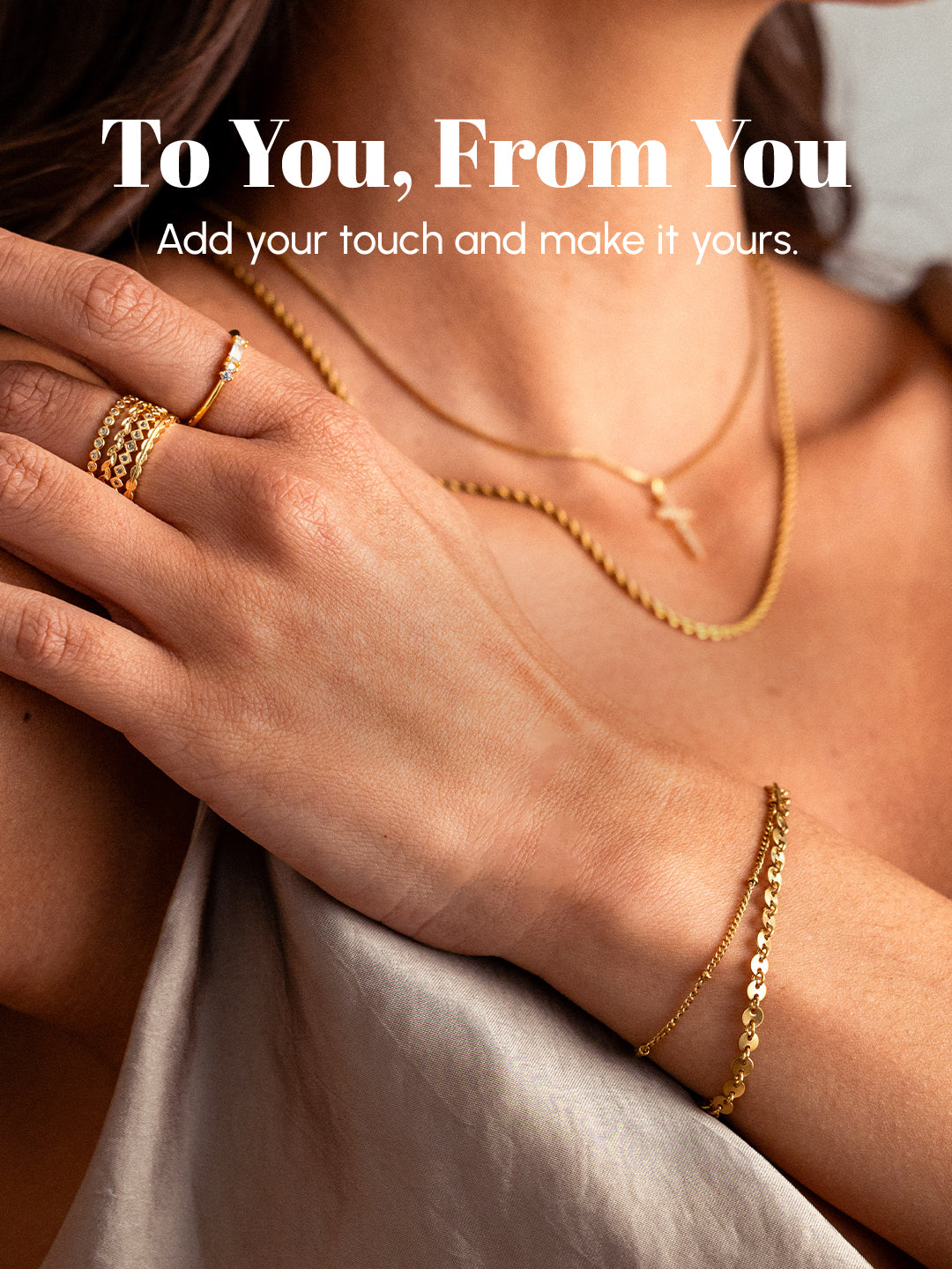 Close-up of a hand wearing gold jewelry with text overlay.