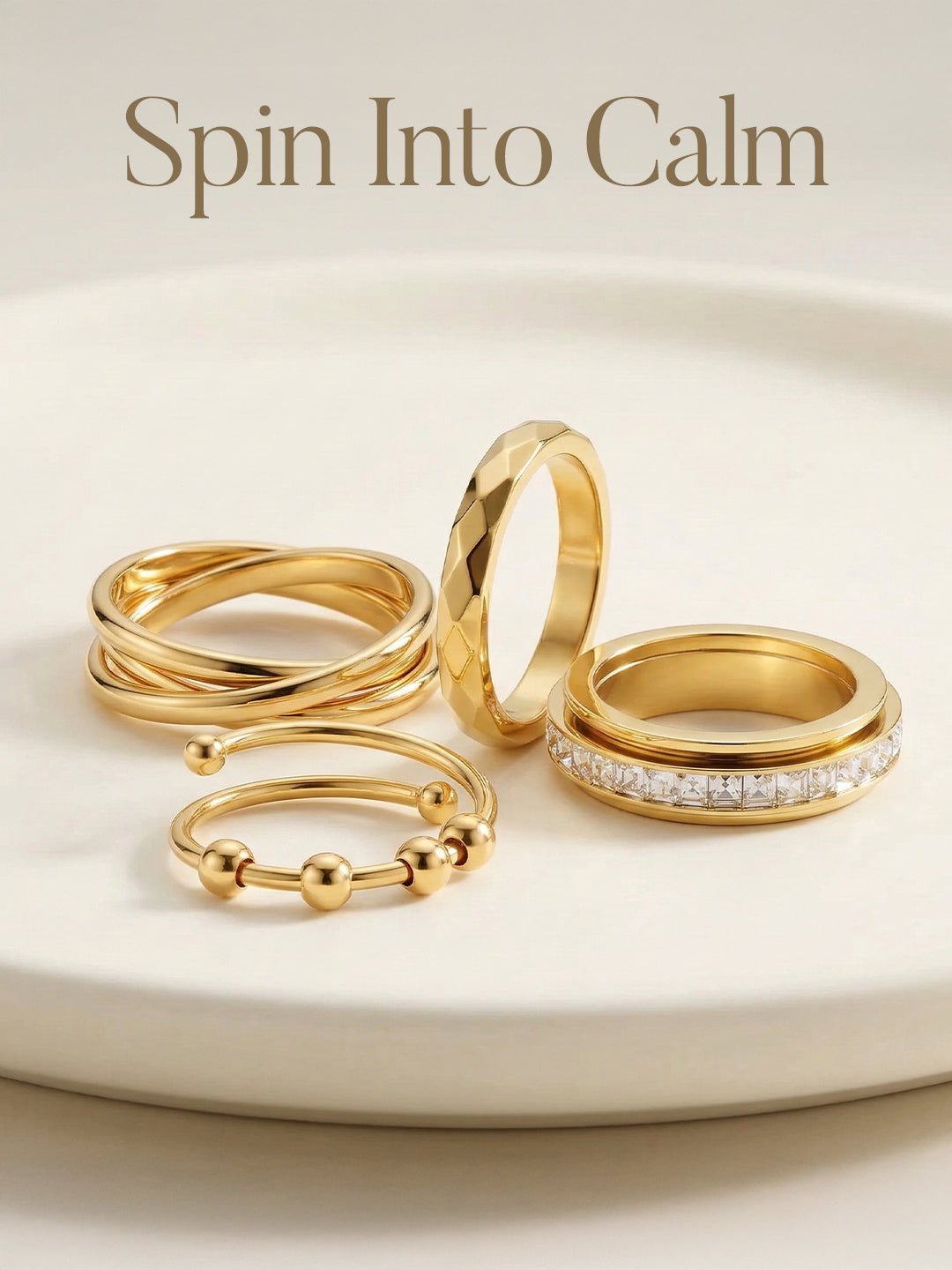 Set of gold rings on a white surface with 'Spin Into Calm' text.