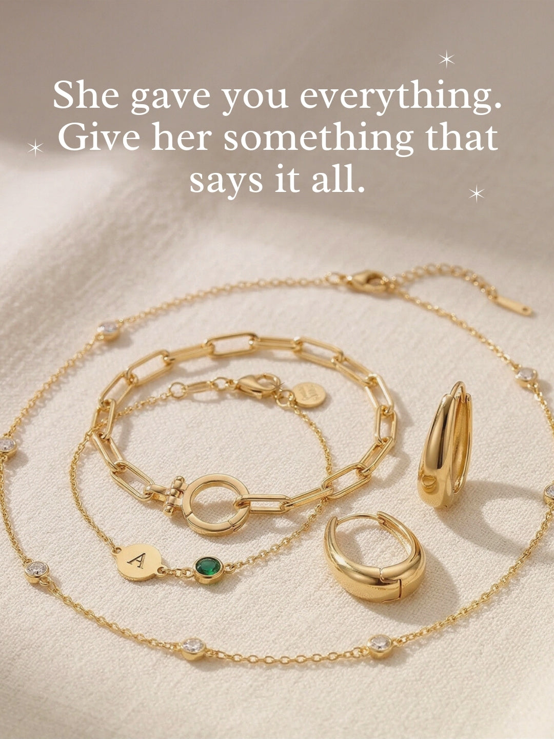 Gold jewelry set with necklaces, bracelets, and earrings with message ‘She gave you everything. Give her something that says it all.