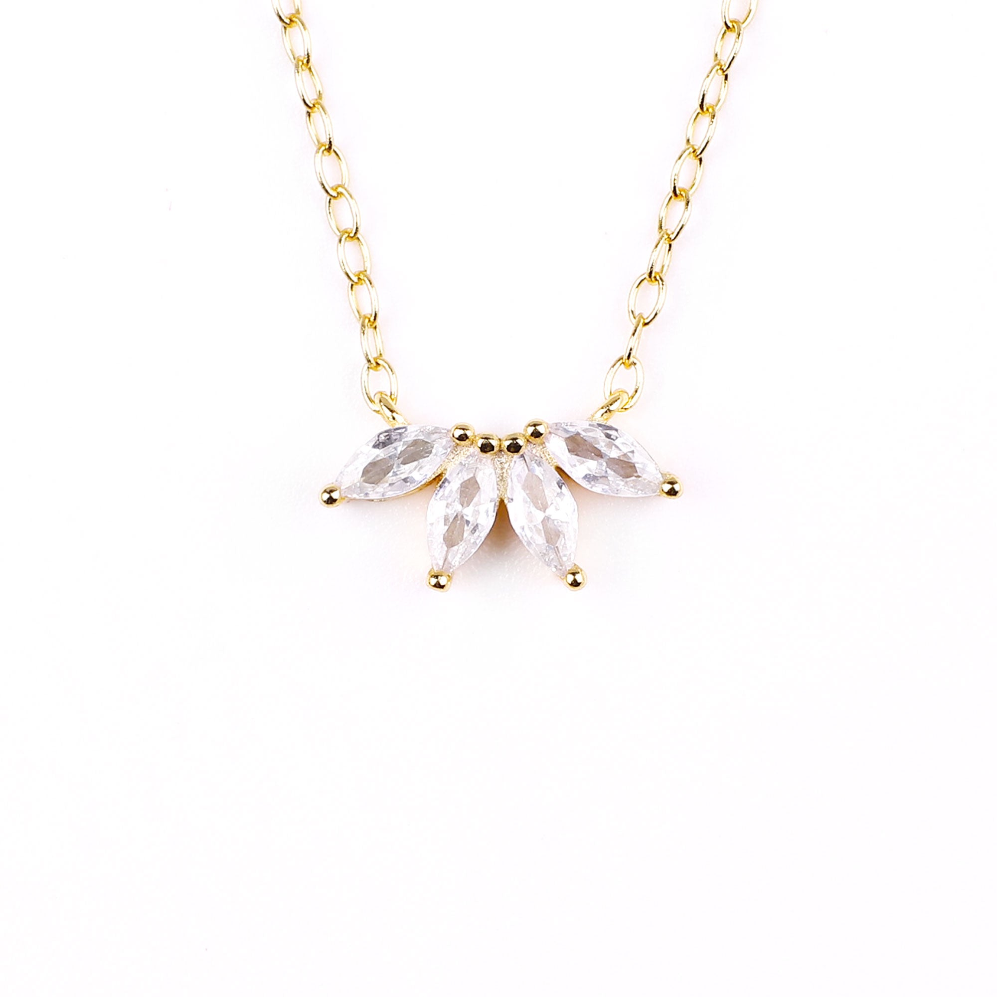 A gold-colored necklace featuring a pair of marquise-cut zircon stones pendant from a chain of round beads.
