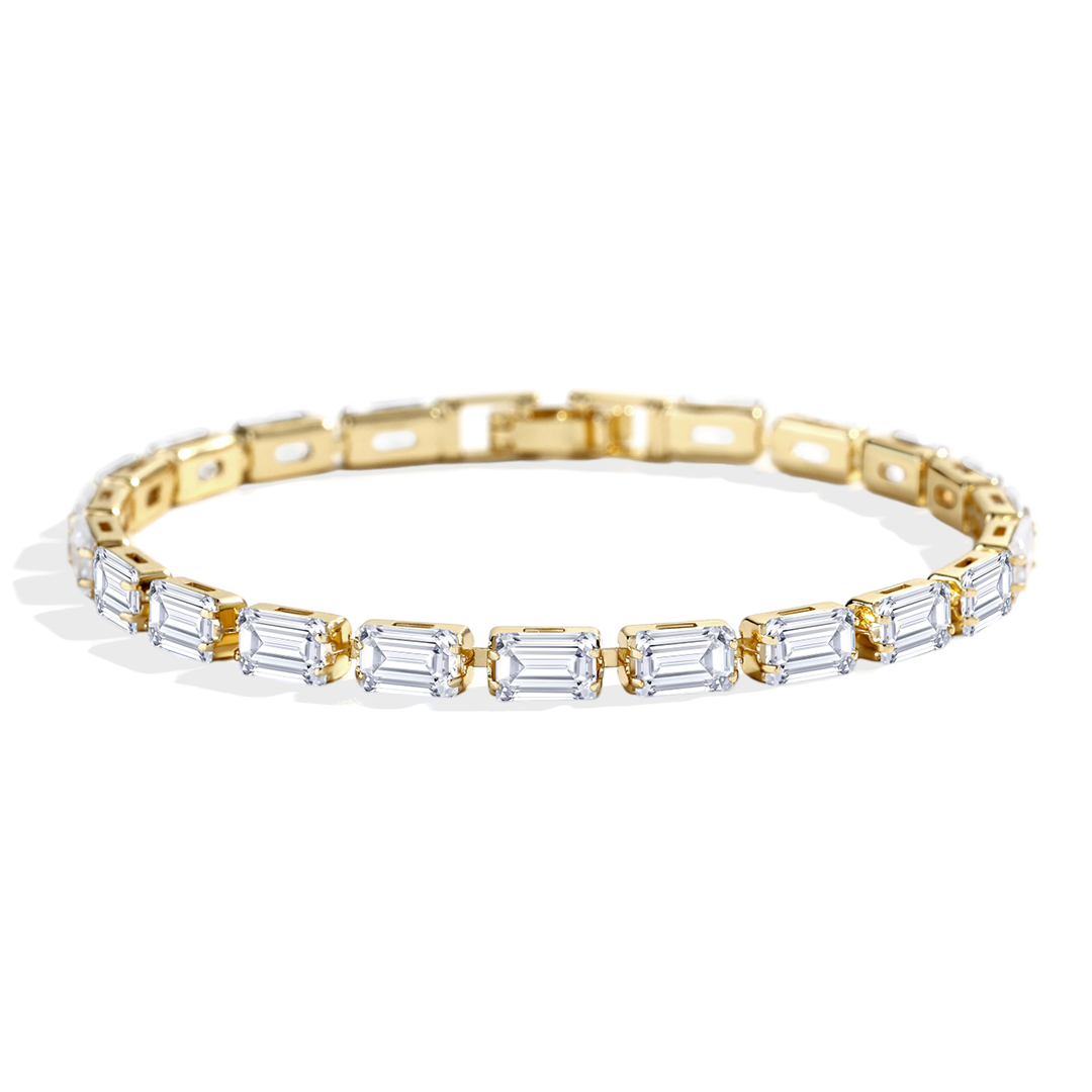 Gold bracelet with baguette-cut diamonds on a white background