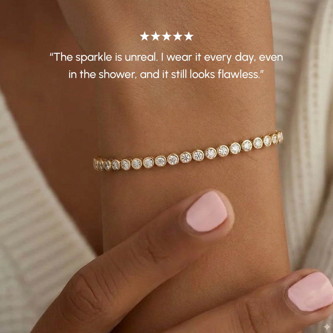 Gold bracelet with clear stones on a wrist, with a neutral background and text about the bracelet's durability.