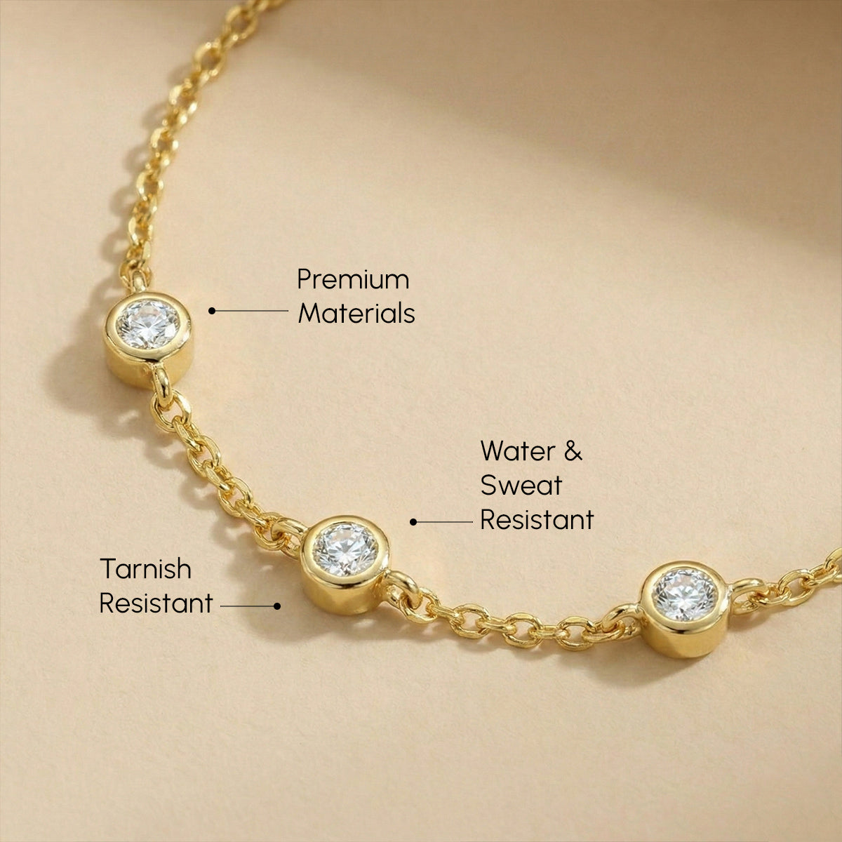 Gold necklace with diamond beads on a beige background, highlighting features.