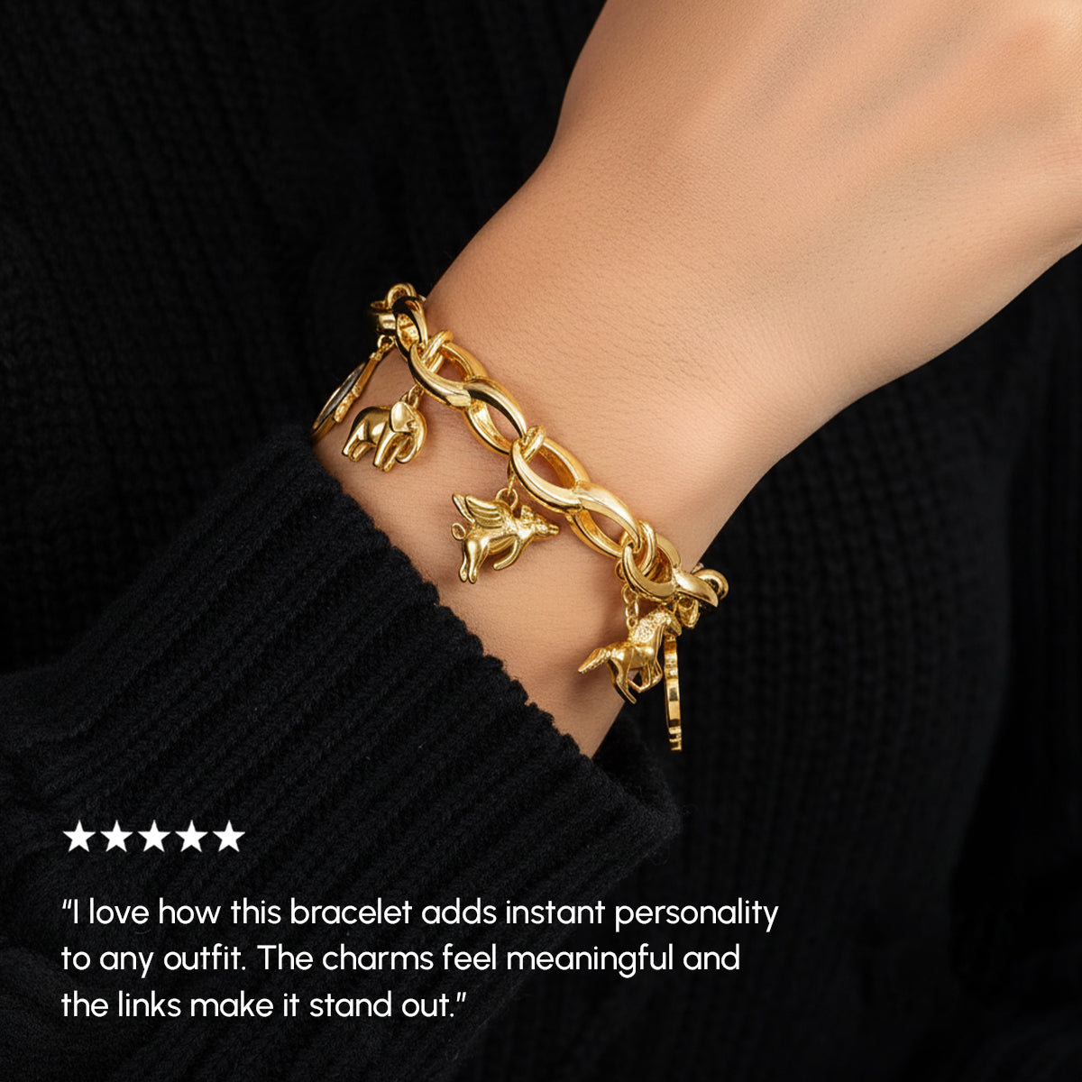 Gold bracelet with charms on a wrist against a black background