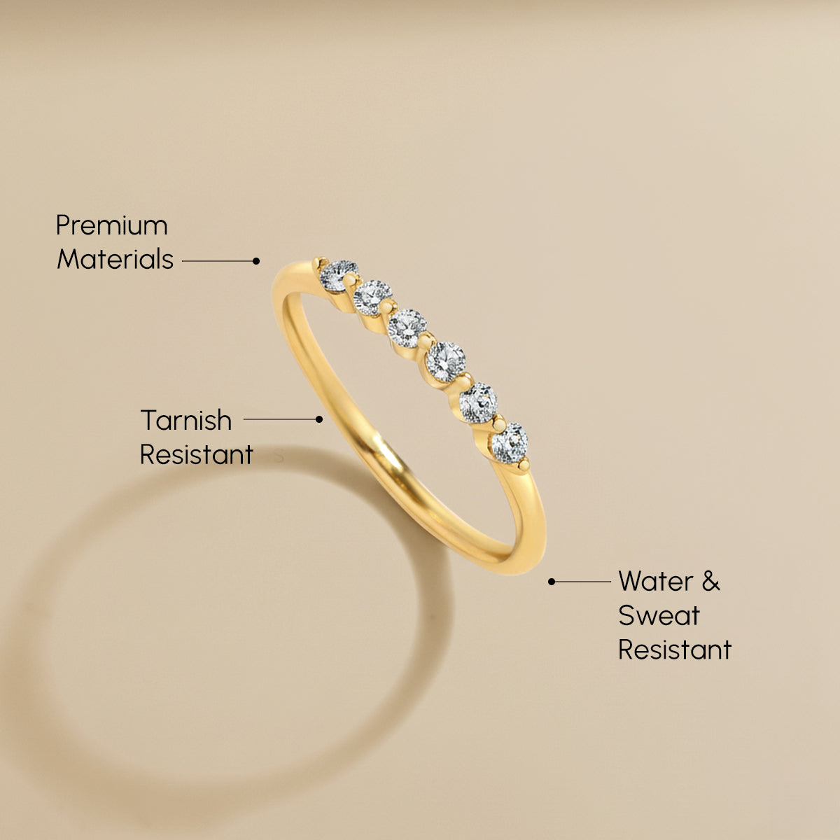 Gold ring with diamonds on a beige background, highlighting features.