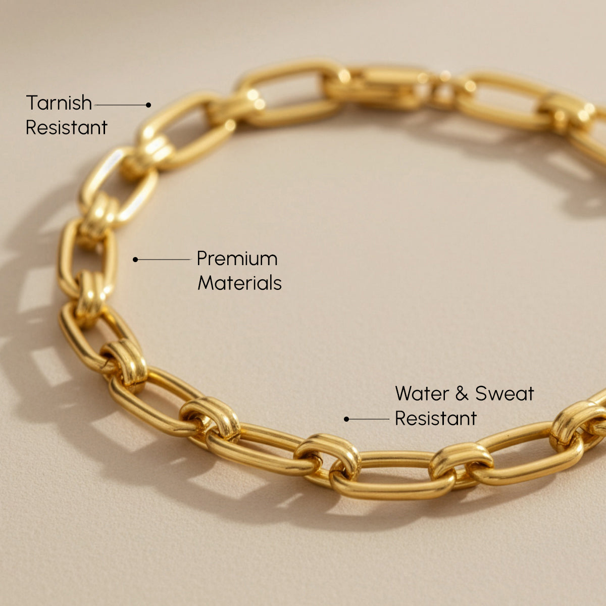 Gold chain bracelet with text highlighting features on a beige background