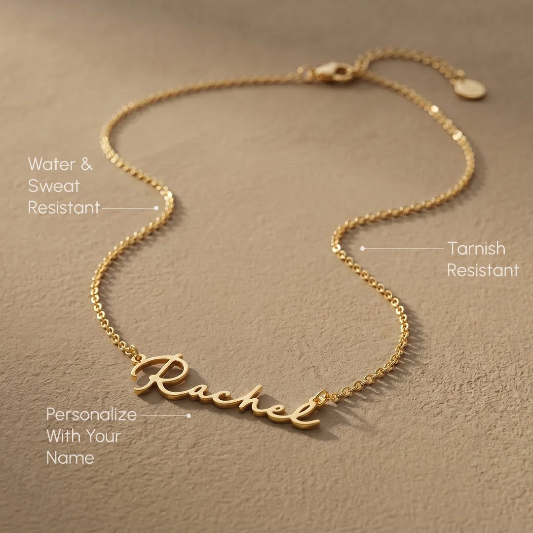 Gold necklace with 'Rachel' engraving on a beige background