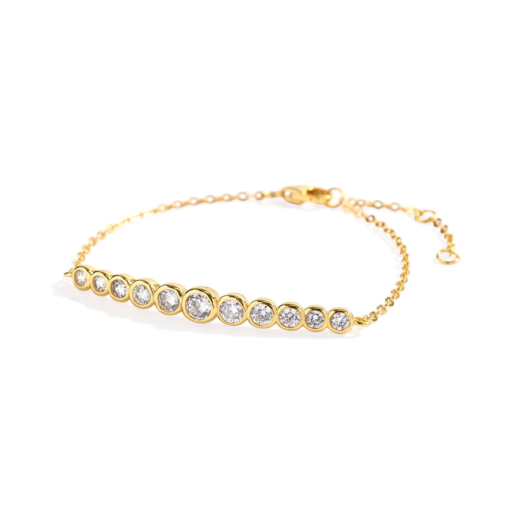 Gold bracelet with embedded crystals on a white background