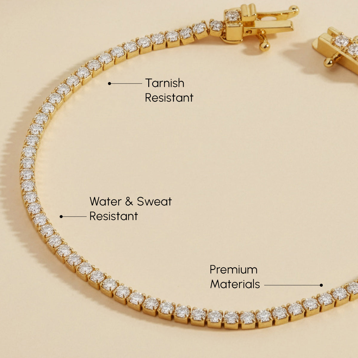 Gold bracelet with diamond accents on a beige background, labeled for features.