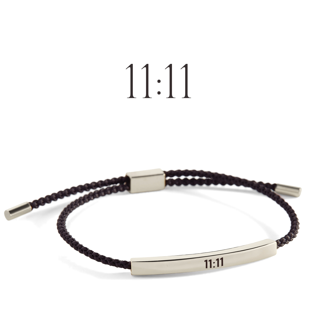 Bracelet with '11:11' engraving on a light gray background