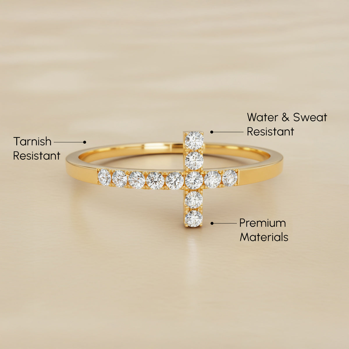 Gold cross-shaped ring with diamond accents on a beige background