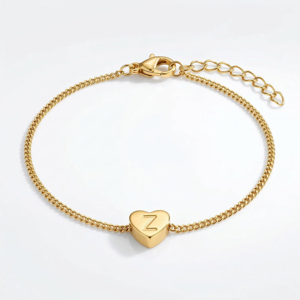 Gold bracelet with a heart-shaped charm displaying the letter 'Z' on a light gray background