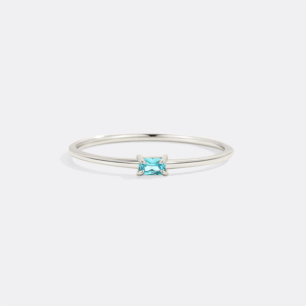 Silver ring with a blue gemstone on a white background