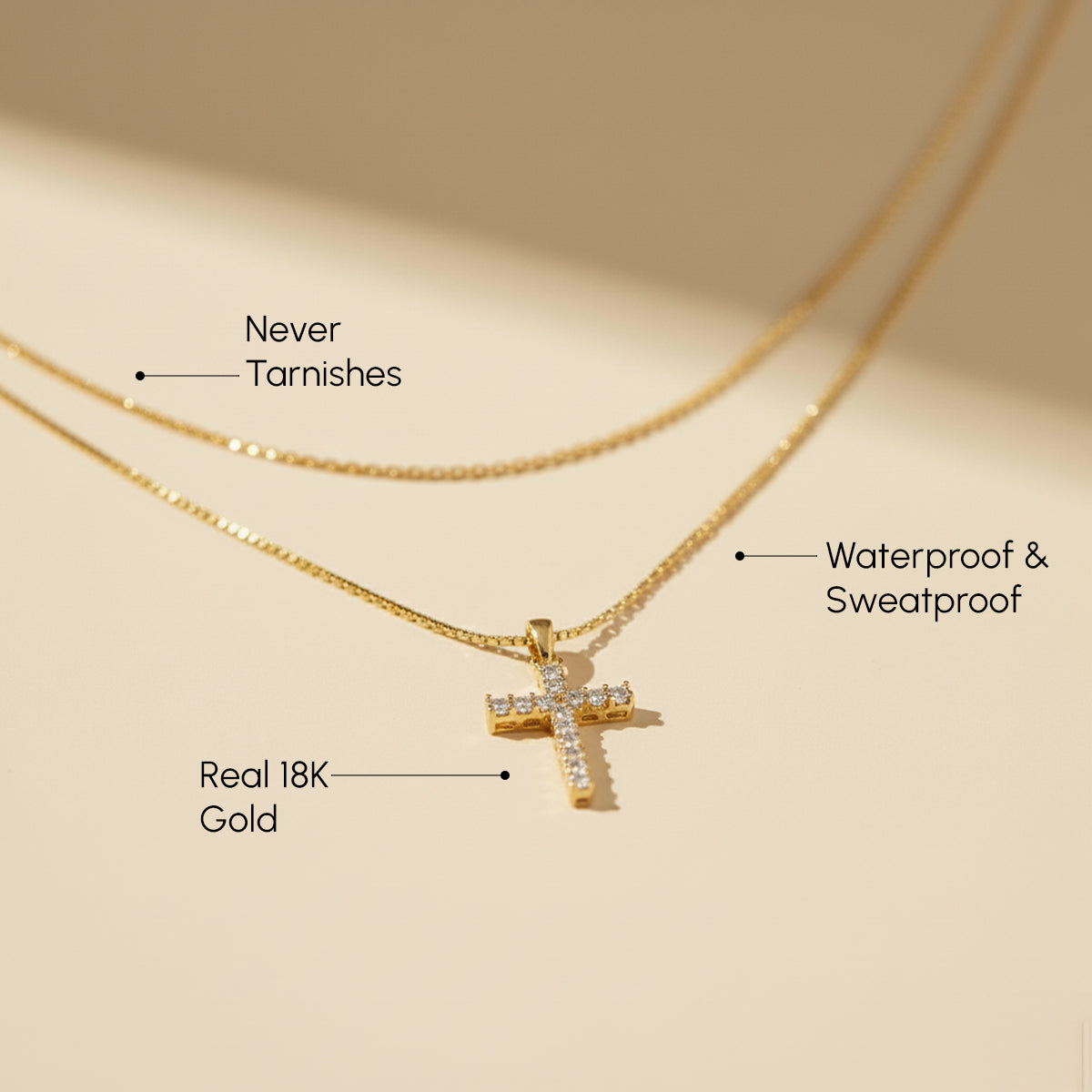 Gold necklace with cross pendant on a beige background
