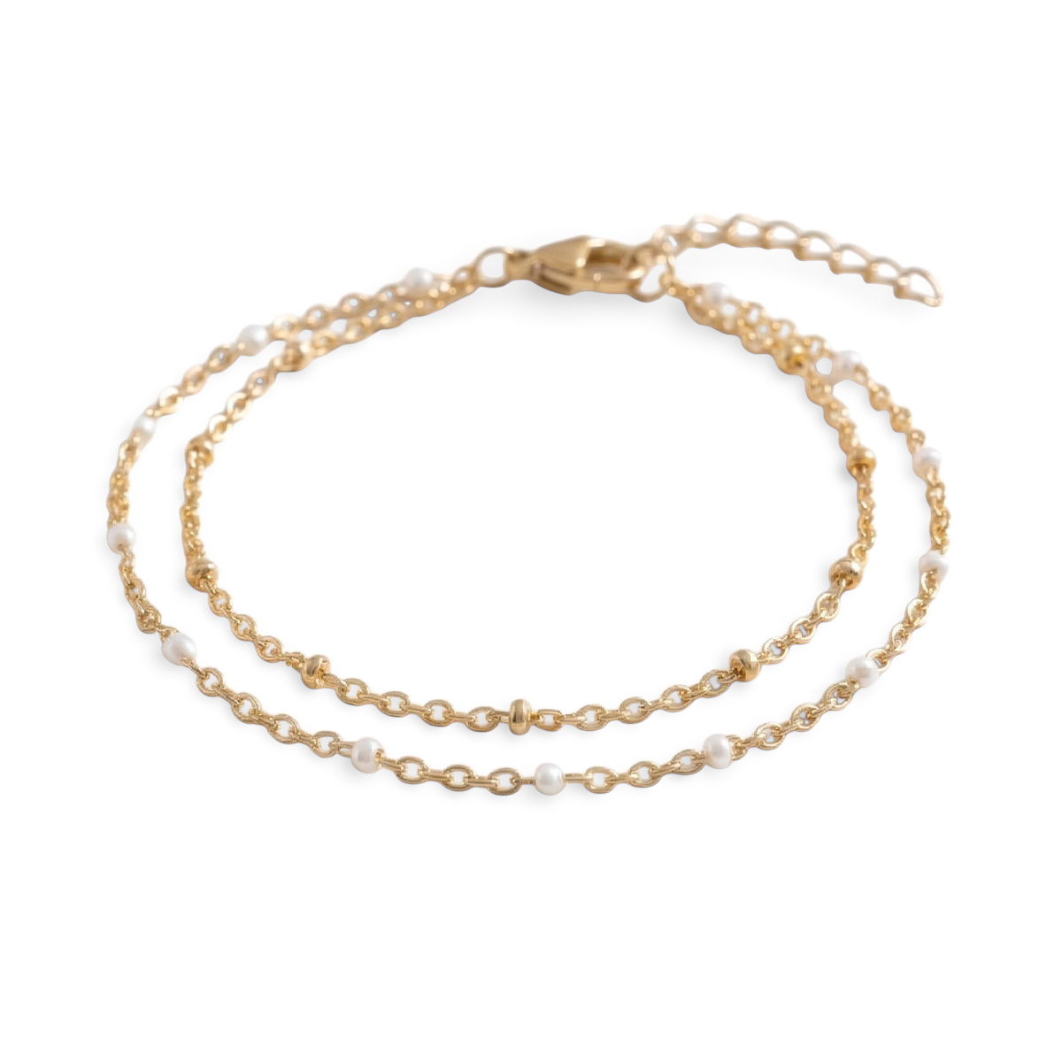 An elegant double chain bracelet accented with fine white accents designed for a refined, understated glow. Perfect for effortless everyday luxury.