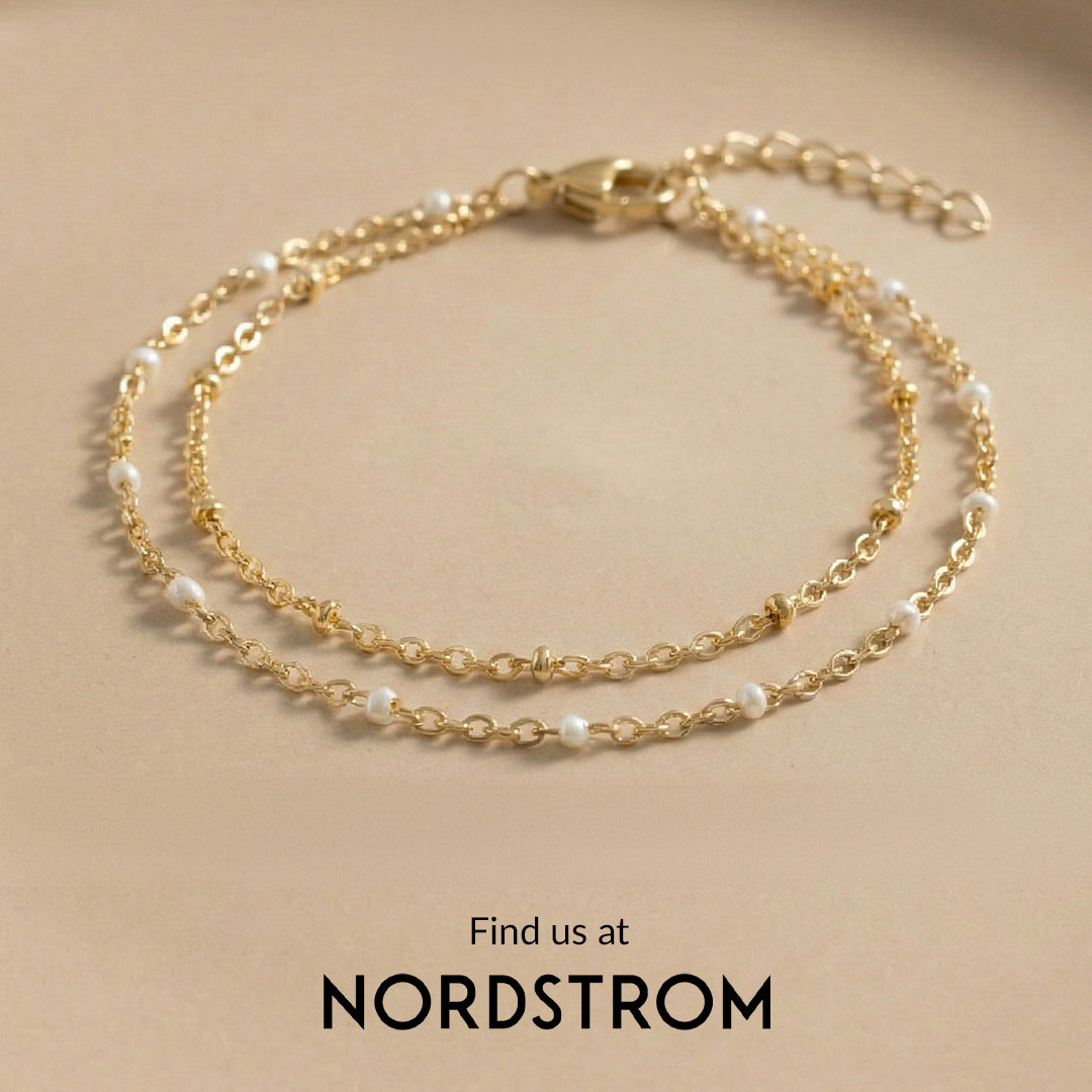 Gold chain bracelet with pearls on a beige background, featuring the brand 'mint & lily' and Nordstrom.