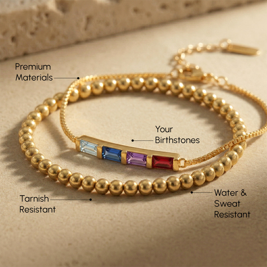 Gold bracelet with embedded stones on a beige background