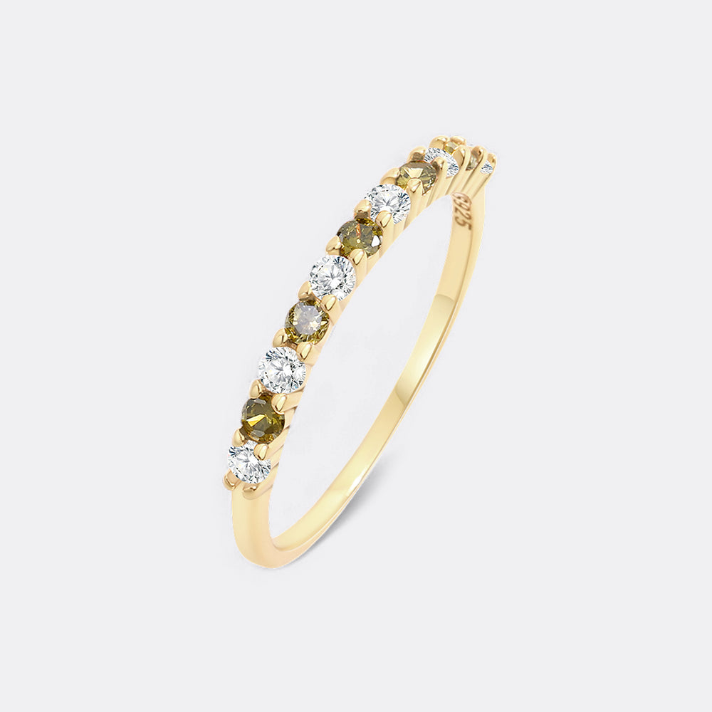 Gold ring with green and clear gemstones on a white background