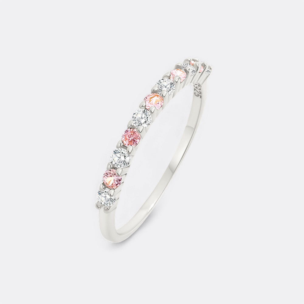 Silver bangle with pink and clear gemstones on a white background