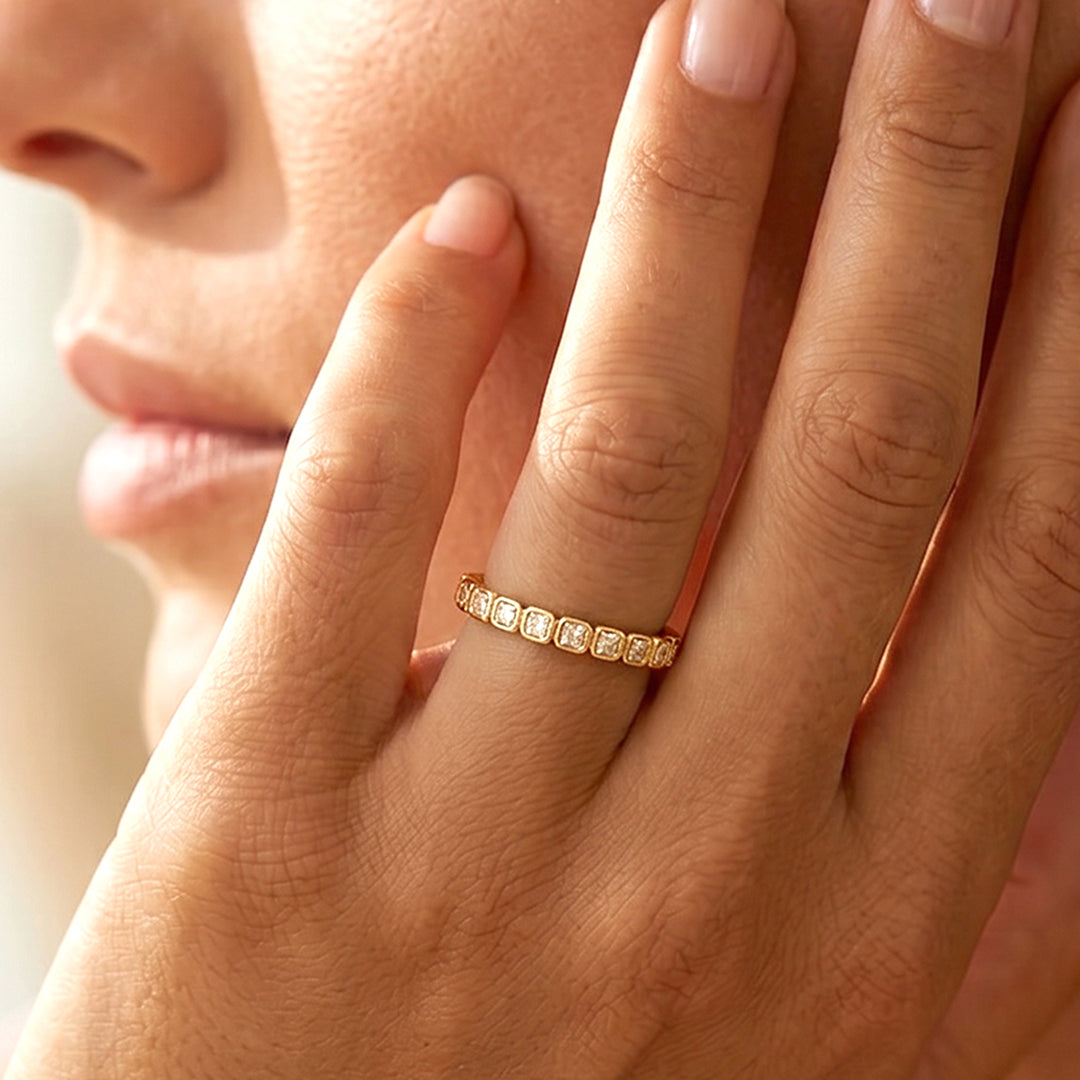 Close-up of a person wearing a ring on a dark background