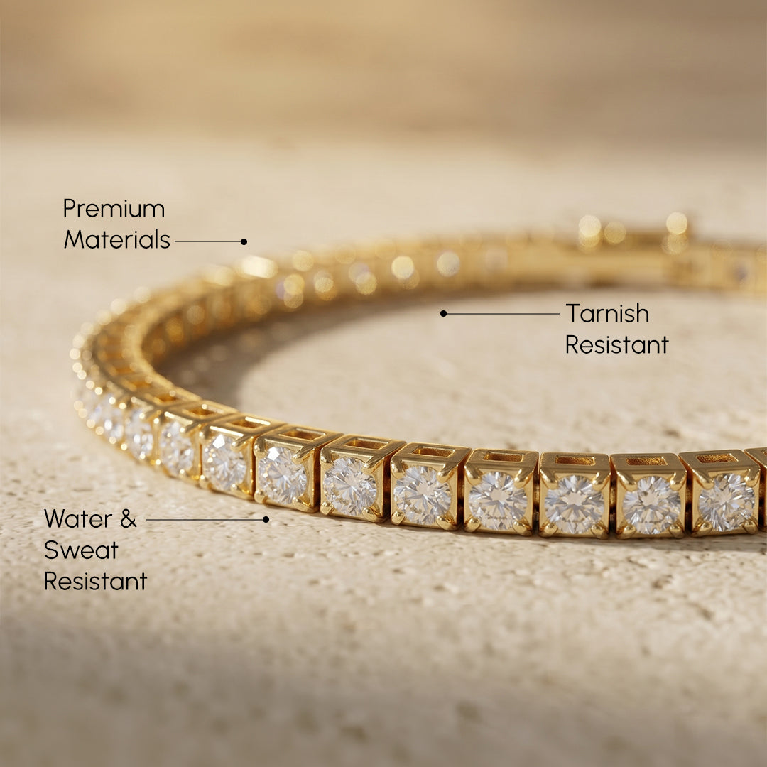 Gold bracelet with diamond accents on a textured surface, labeled for material and resistance properties.