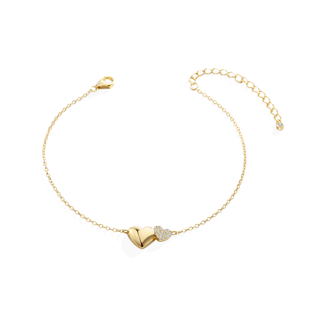 Gold bracelet with heart-shaped clasp on a light gray background