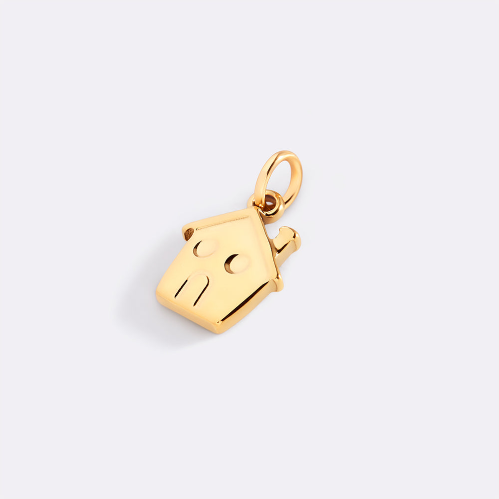 Gold pendant shaped like a house on a light gray background
