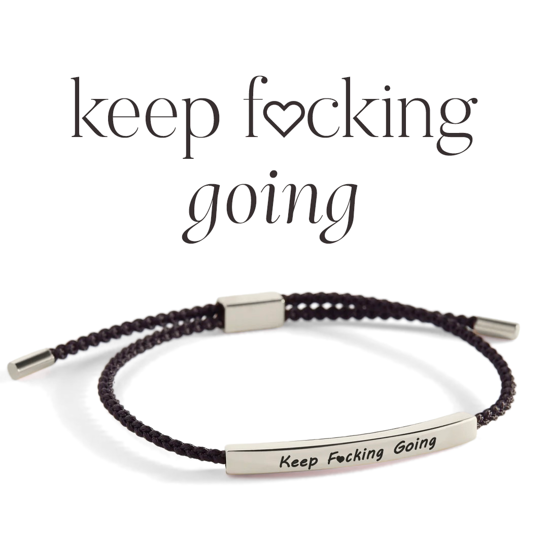 A braided bracelet with metal accents, featuring the inscription 'Keep Fcking Going'.