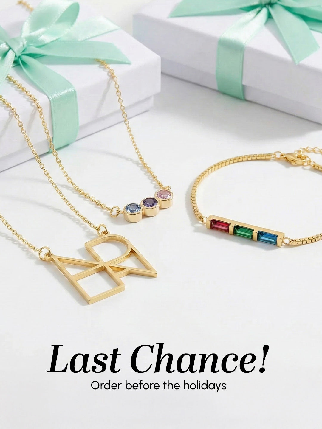 Gold jewelry with gemstones on a white surface with gift boxes and text 'Last Chance! Order before the holidays'.