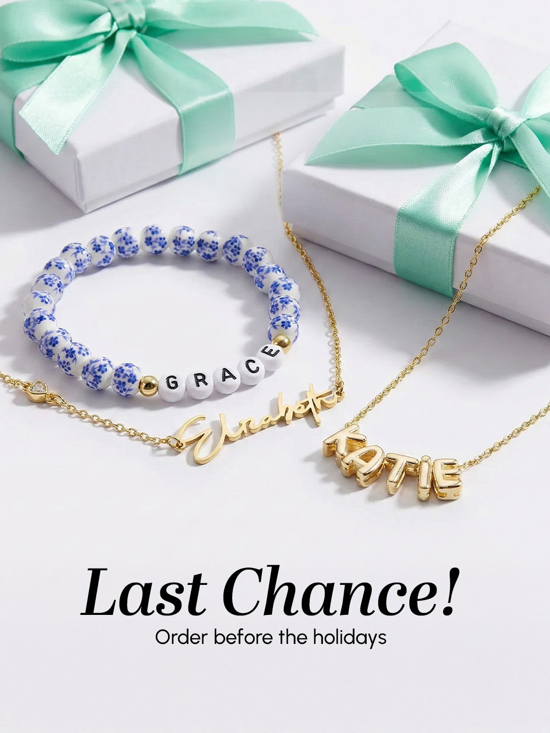 Jewelry set with name bracelets on a white surface with gift boxes in the background.