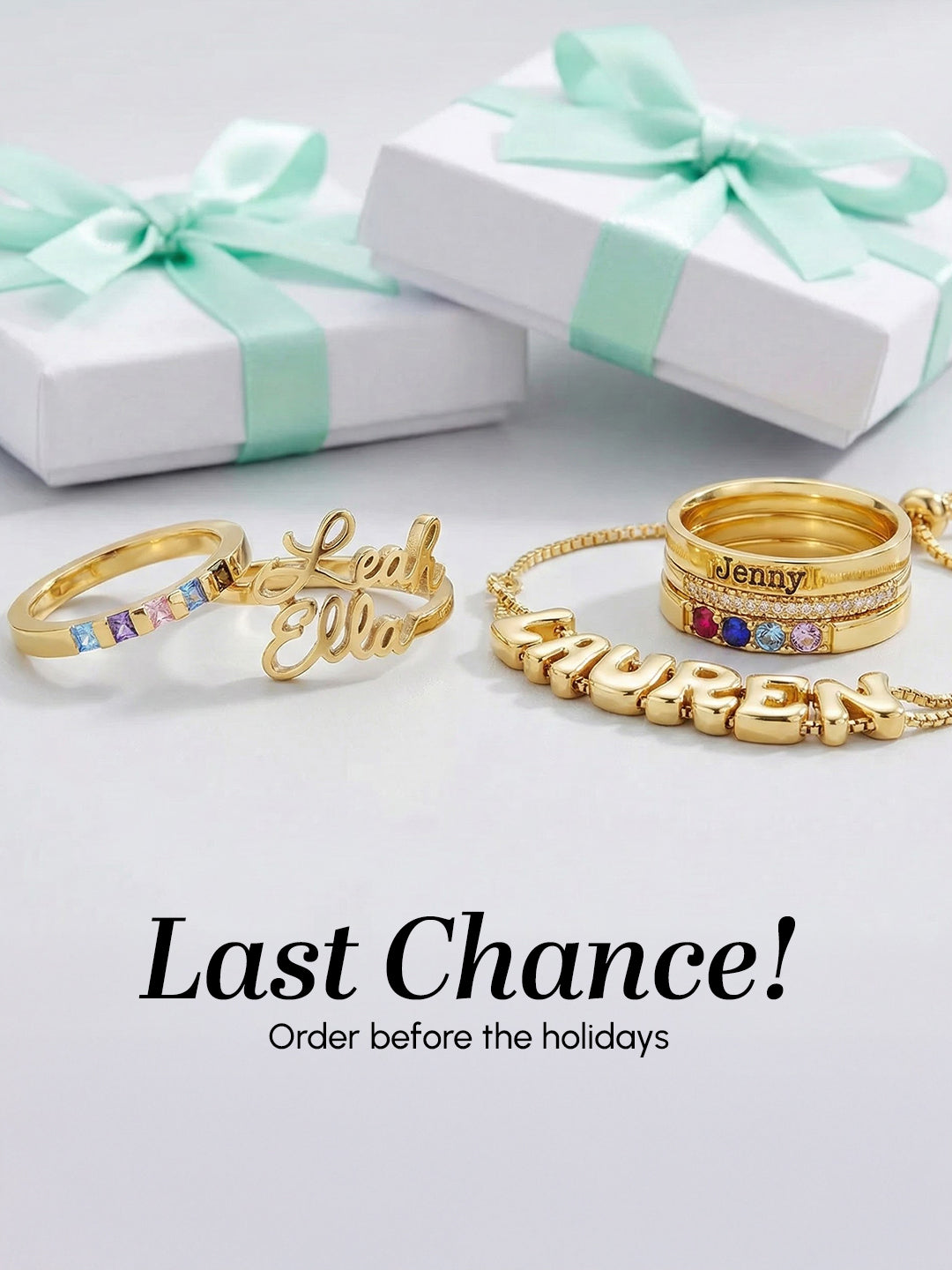 Gold jewelry with engraved names on a white surface with gift boxes.