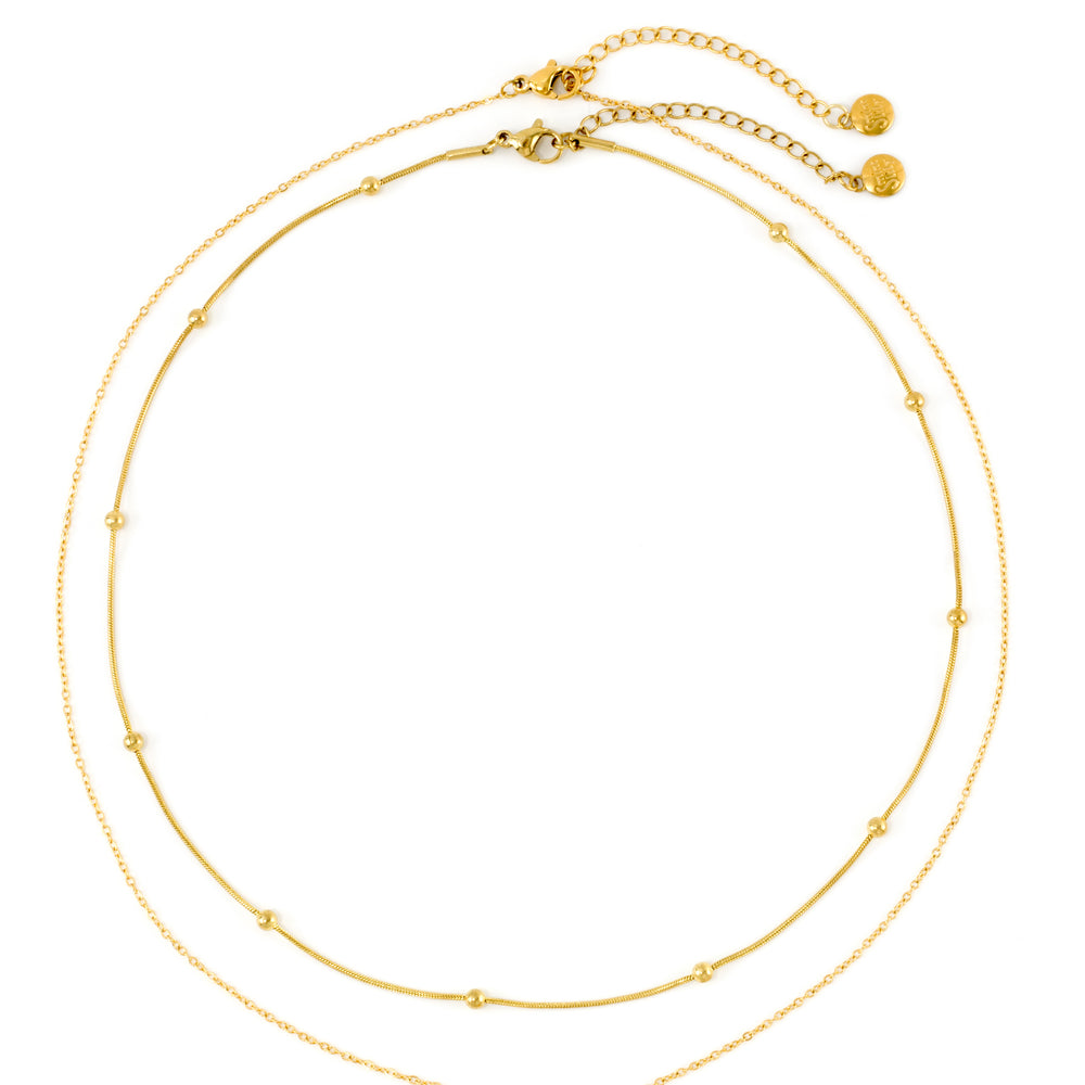 Gold Layered Double Chain Necklace laid flat on white, the beaded satellite chain nested inside the solitaire pendant chain, both shown whole from clasp to clasp.