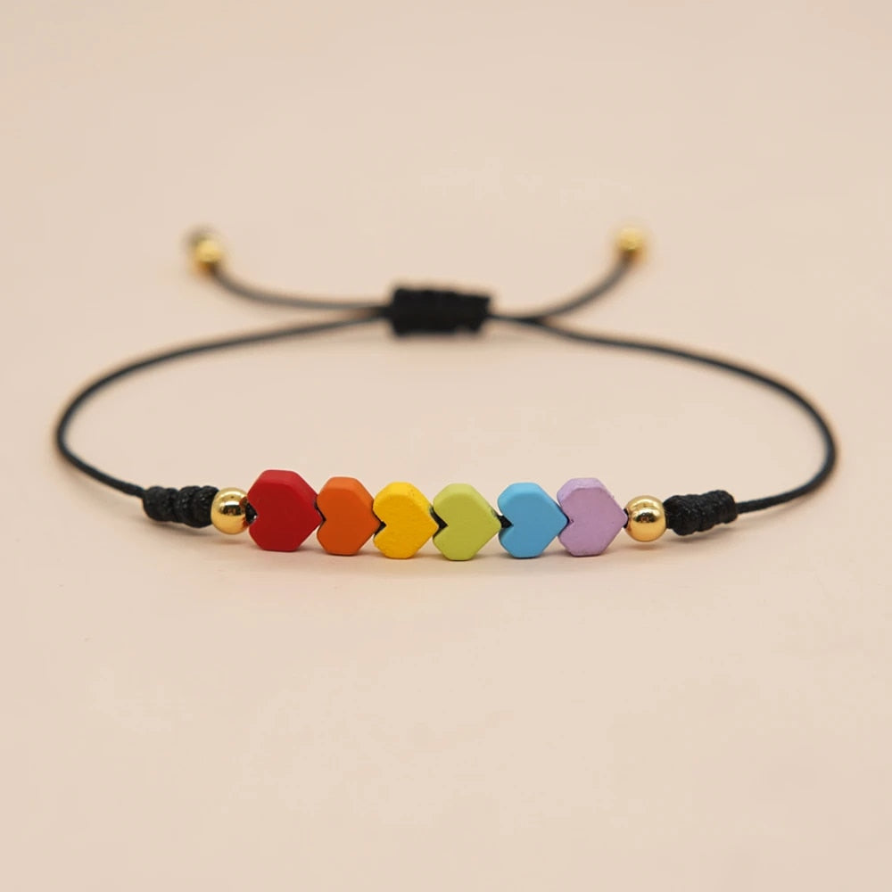 An adjustable bracelet with a black strap and a series of multicolored heart-shaped beads.