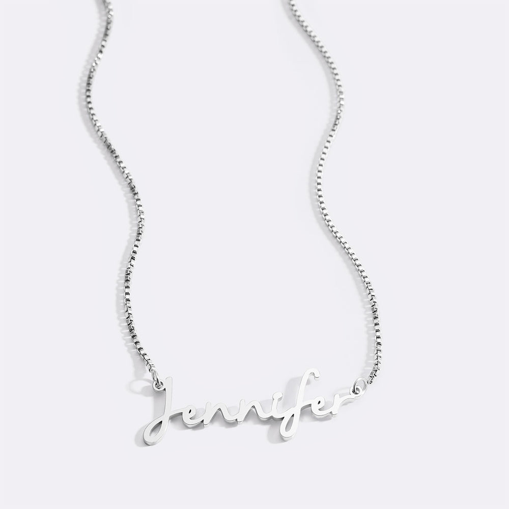 Silver name necklace on a white background