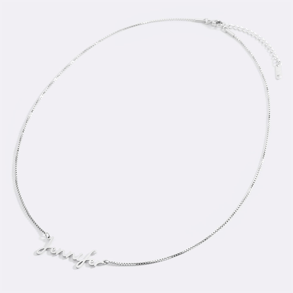 Silver necklace with 'fame' pendant on white background