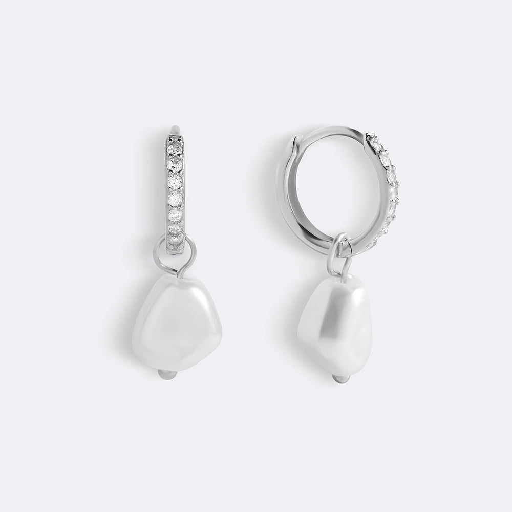 Pair of silver earrings with pearls and gemstones on a white background
