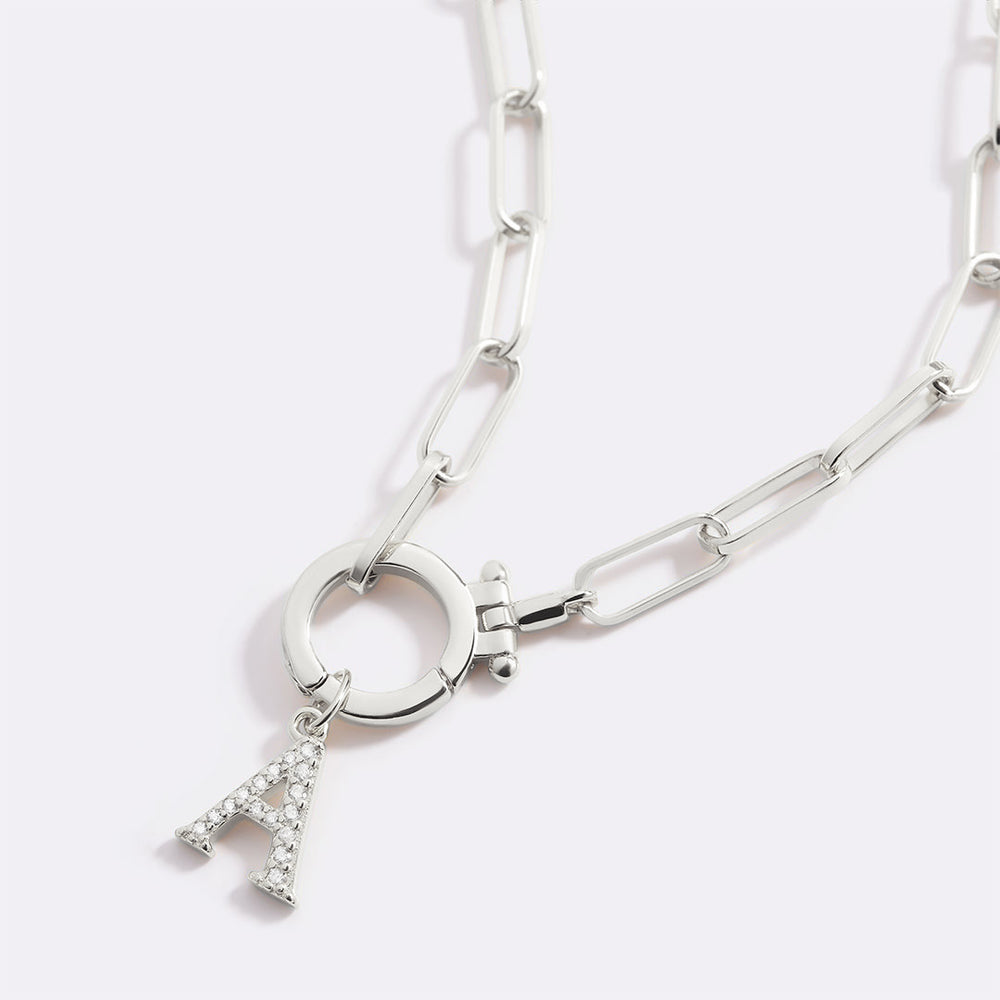 Silver chain bracelet with a letter 'A' charm on a light gray background