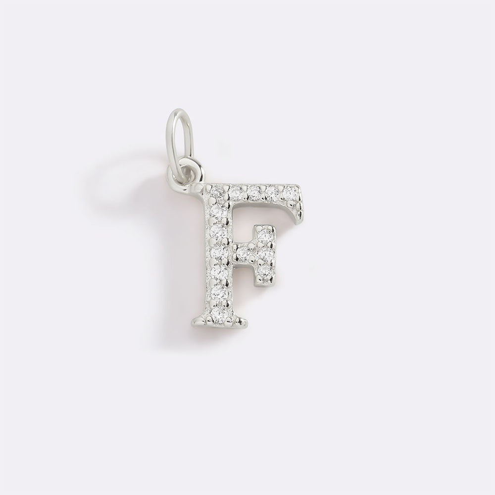 Silver pendant with letter 'F' on a light gray background