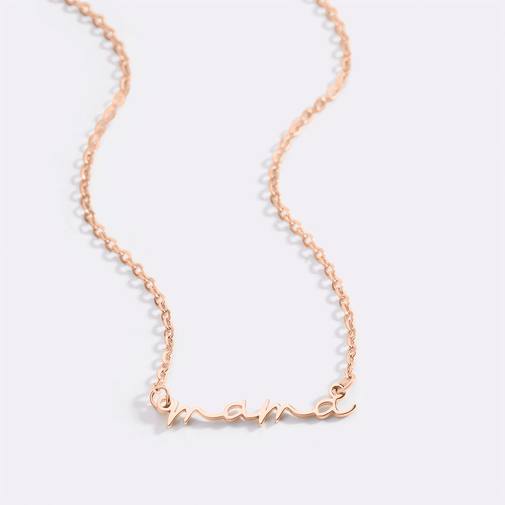 A dainty mama necklace with a two-tone design featuring a gold-colored nameplate and a cable chain.