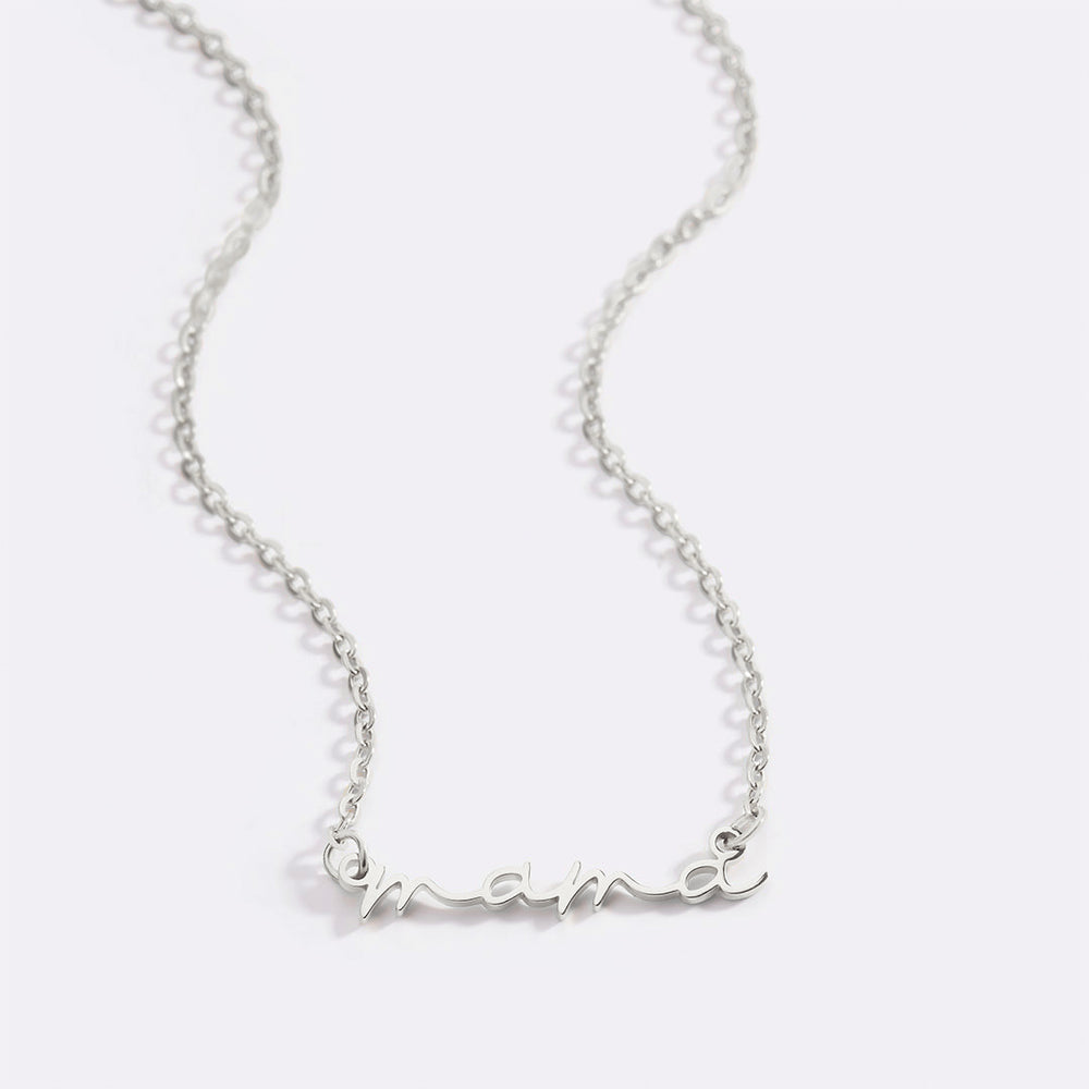 A dainty mama necklace with a two-tone design featuring a gold-colored nameplate and a cable chain.
