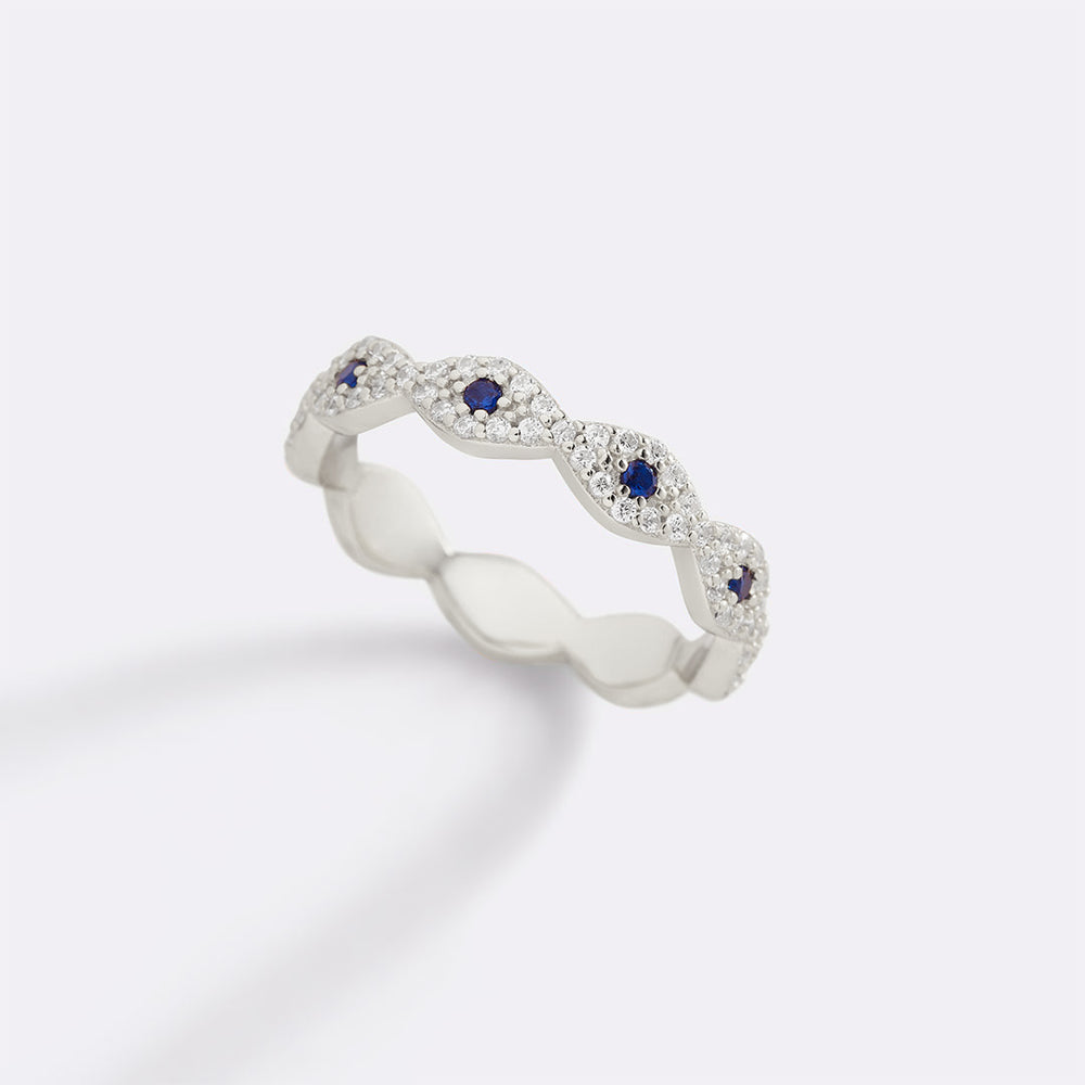 Silver ring with blue gemstones on a white background