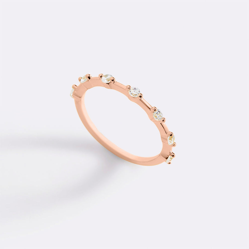 A gold-colored ultra thin floating eternity ring with multiple small clear accents around the band.
