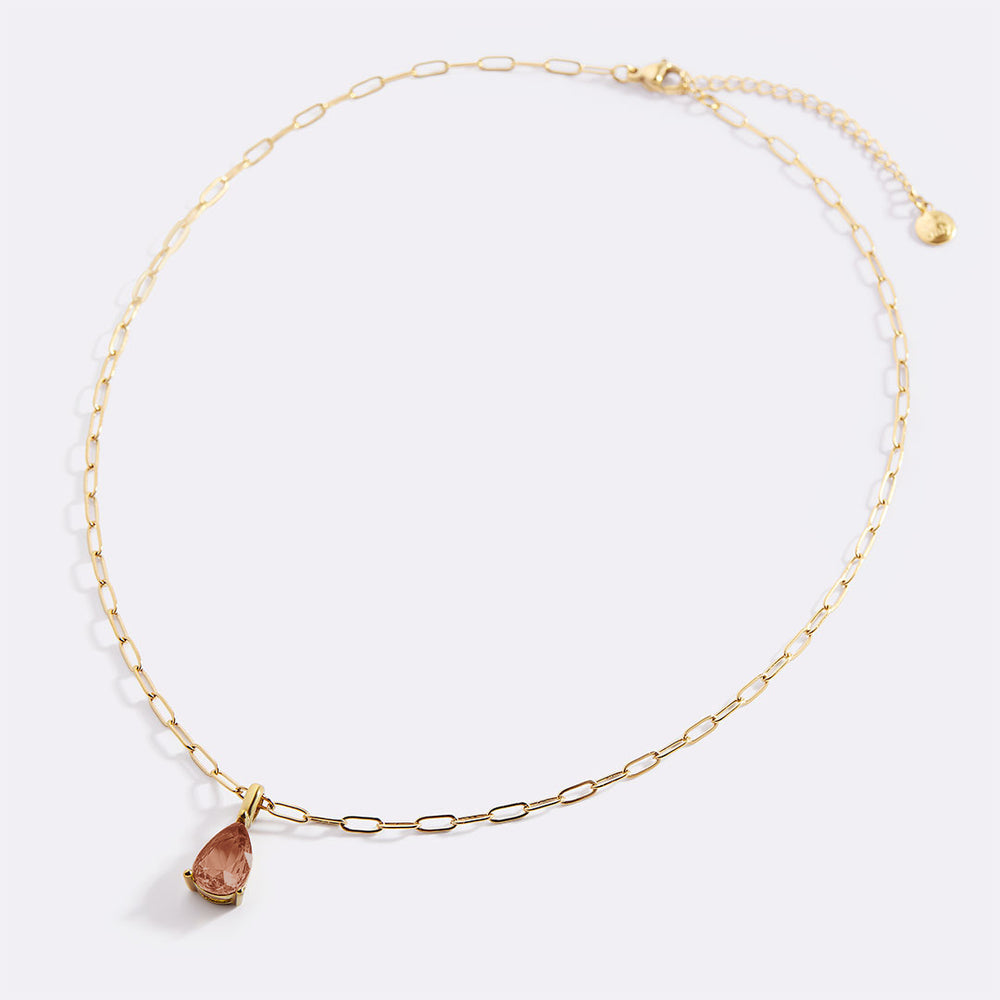 Gold necklace with a teardrop-shaped pendant on a white background