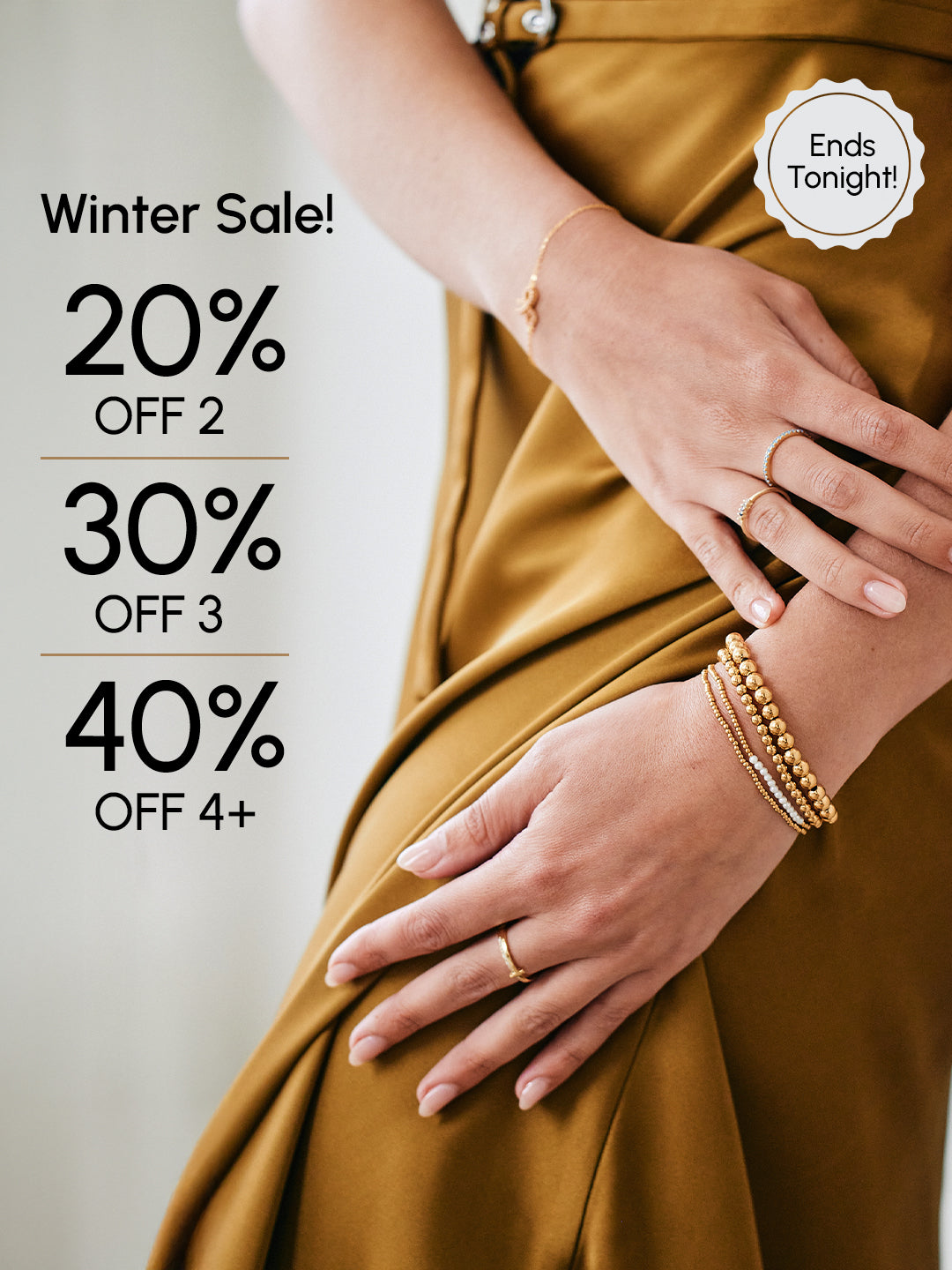 Promotional graphic with hands wearing gold jewelry and text about a winter sale offer.