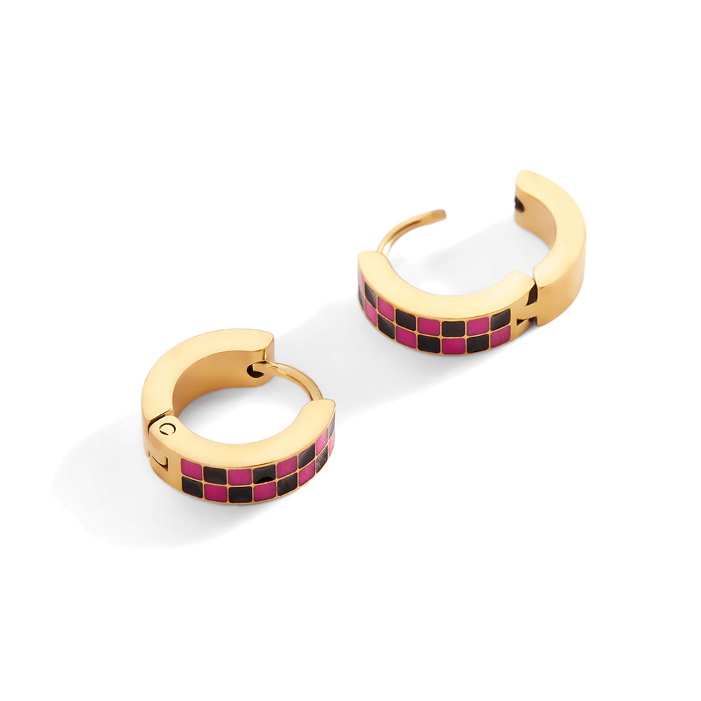 Gold hoop earrings with pink and black checkered pattern on a white background