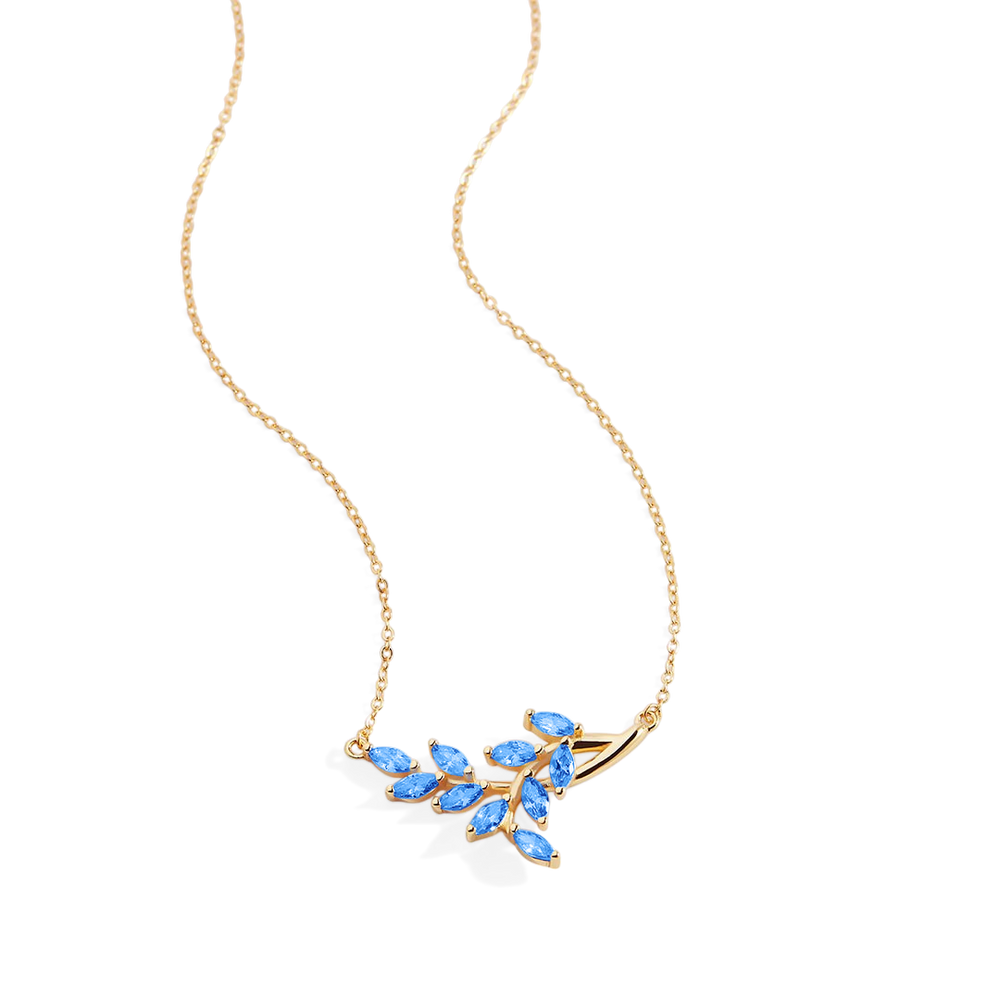 Gold necklace with blue gemstones on a light gray background